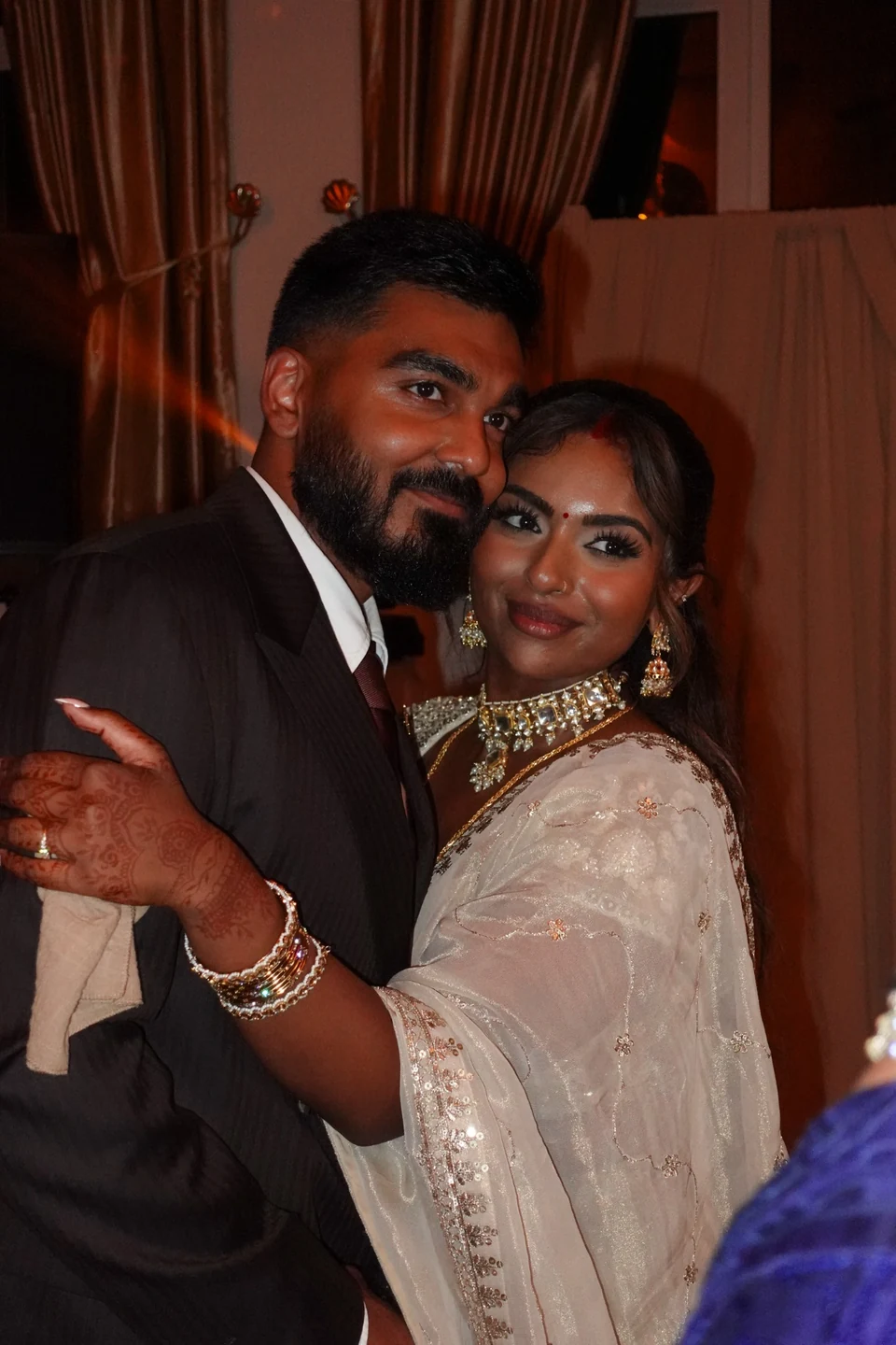 A couple embracing at an evening celebration